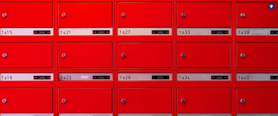 A wall of red post boxes arranged in a grid