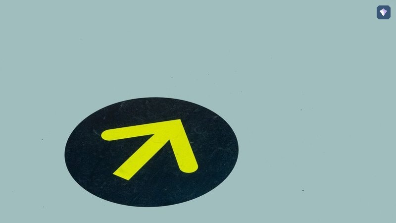 A yellow arrow painted on a blue floor pointing one way