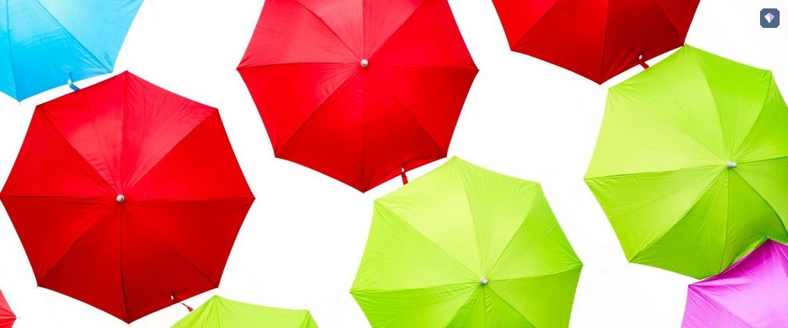 Open umbrellas in red and green seen from above