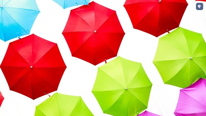 Open umbrellas in red and green seen from above