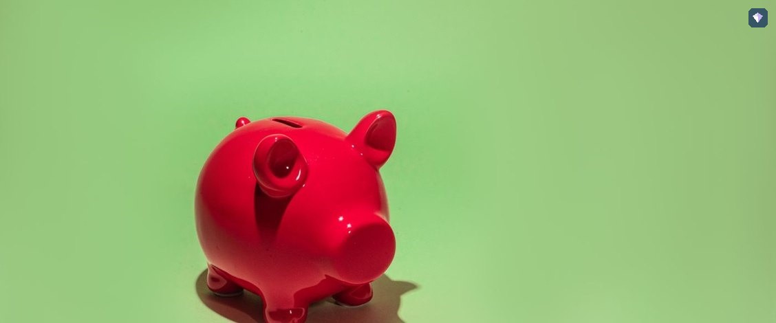 A red piggy bank on a green background