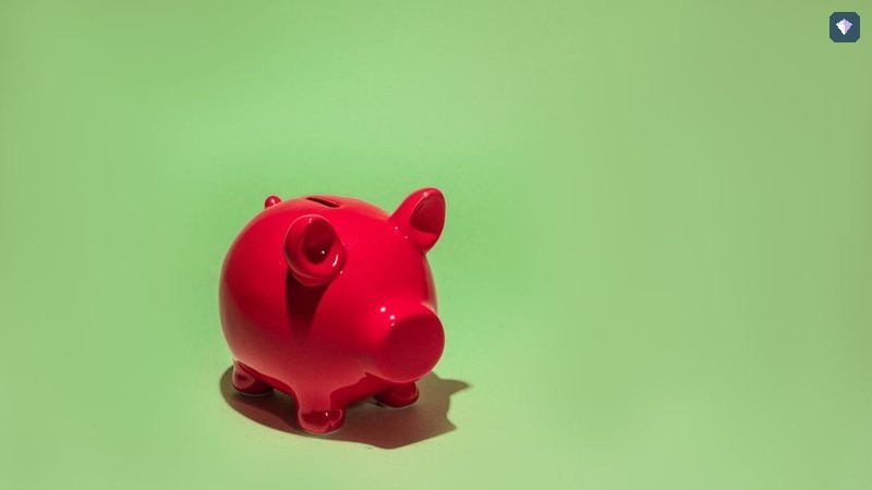 A red piggy bank on a green background