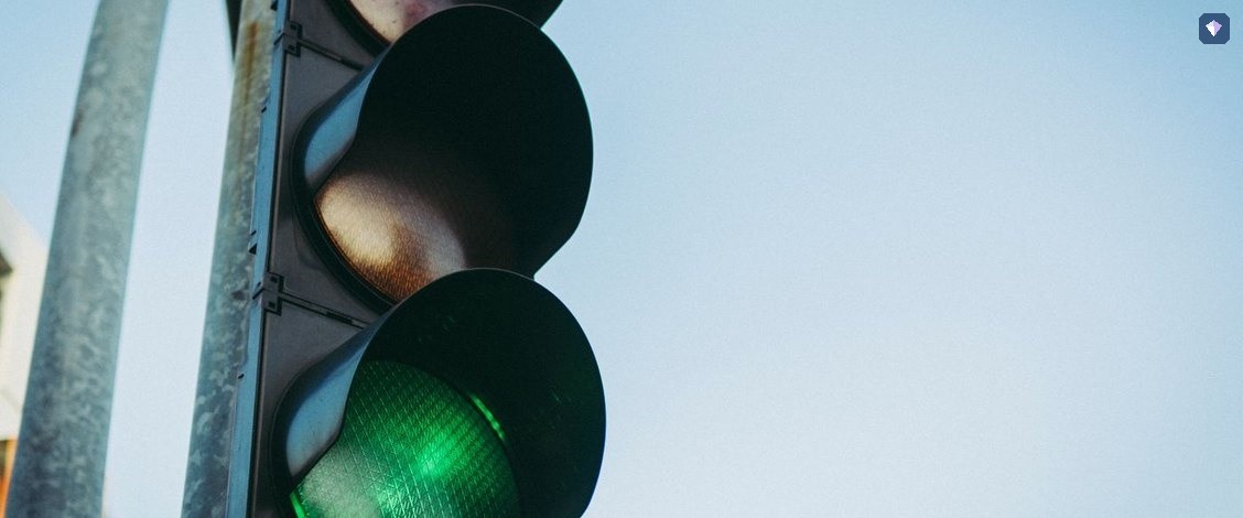 A traffic light showing green against a clear sky