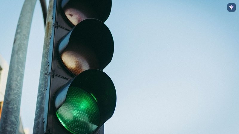 A traffic light showing green against a clear sky