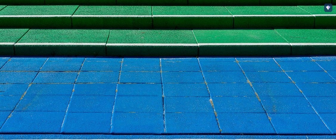 Steps painted in blue and green rising in a stairway