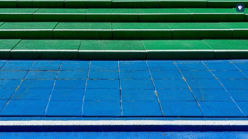 Steps painted in blue and green rising in a stairway