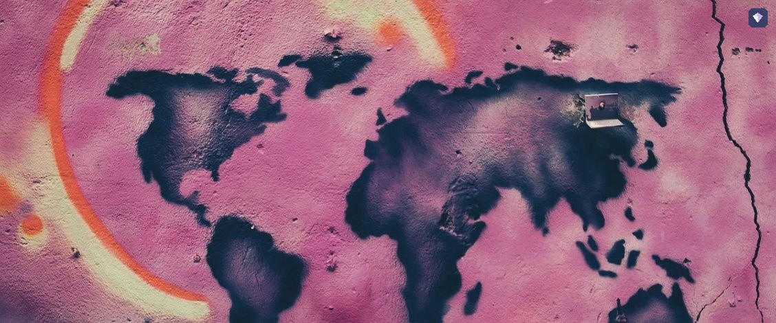 A world map painted on a pink and cream wall