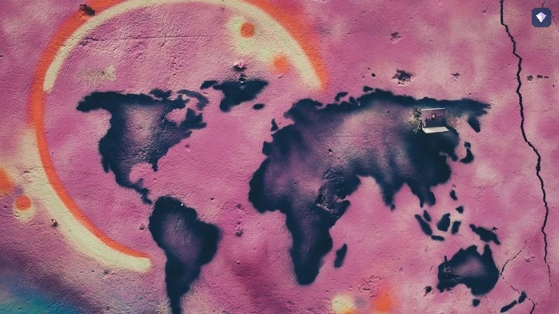 A world map painted on a pink and cream wall