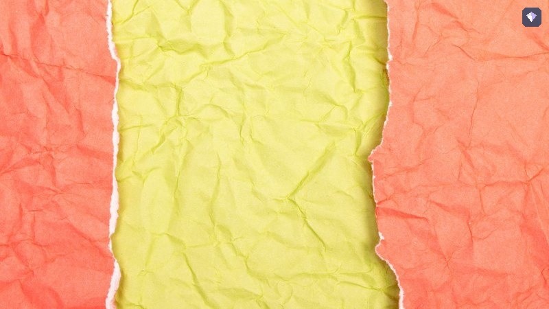 Red and yellow paper torn across the middle